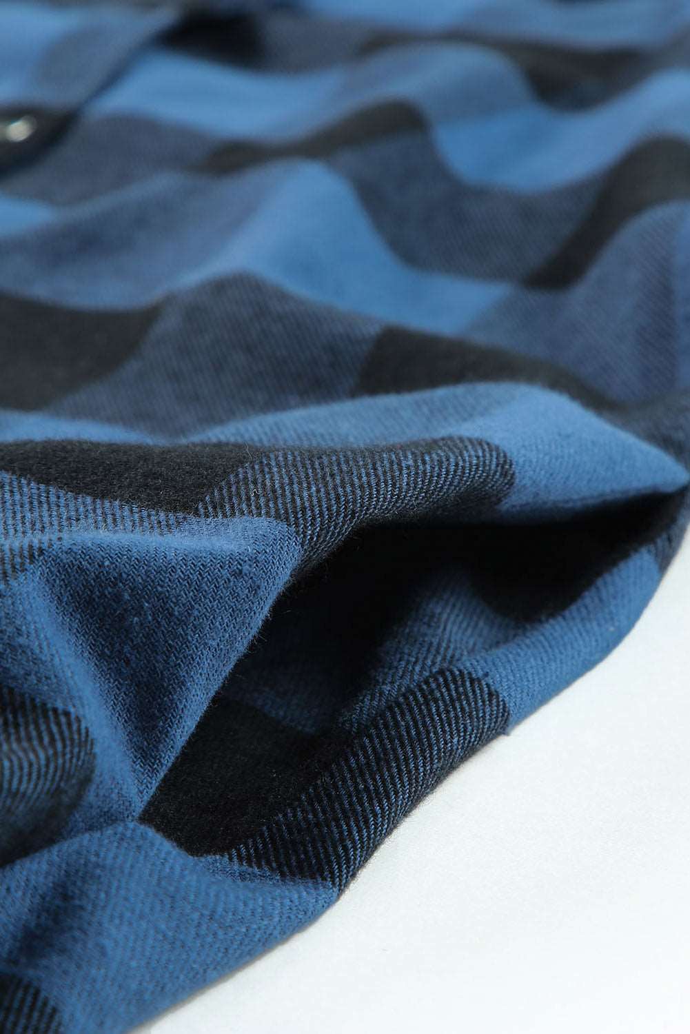 Chemise veste à carreaux bleue à col rabattu.